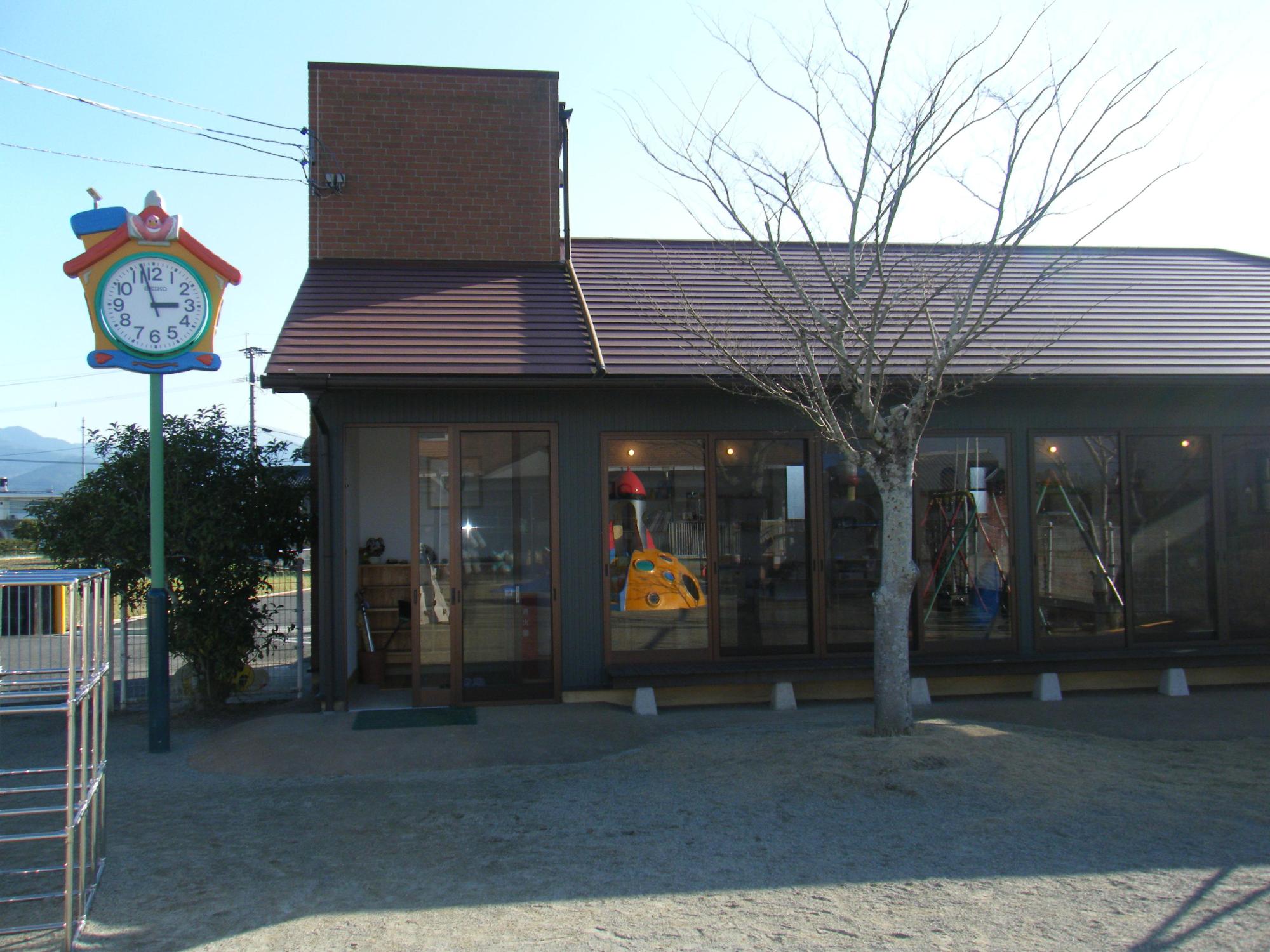 光台寺保育園子育て支援センターの外観写真。外には砂の広場がある。